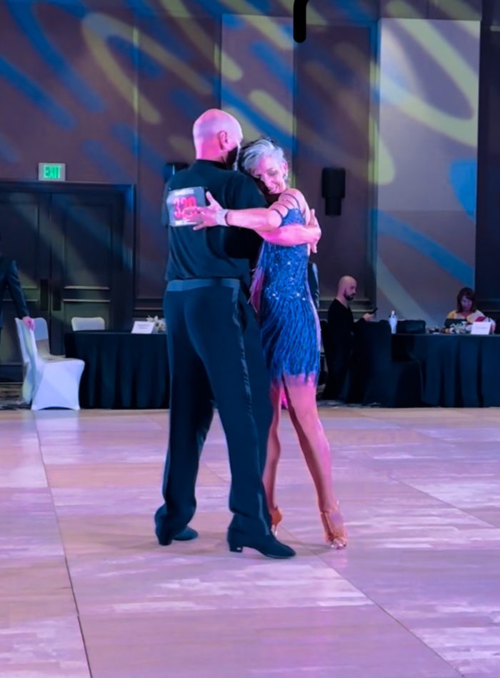 Mary dancing latin in a blue dress