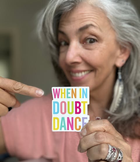 Mary holding a sticker reading When in doubt dance